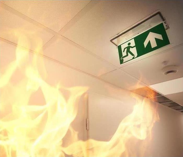 Flames on building, evacuation sign