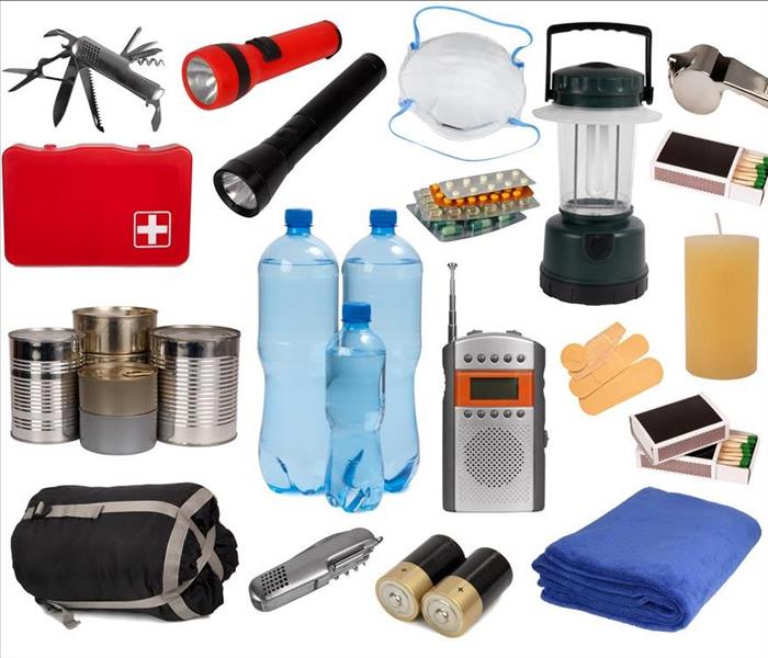 Disaster kit supplies. Water, food, flashlights and batteries